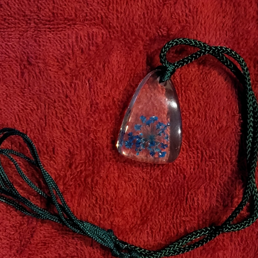 Leaves in clear plastic pendant.
